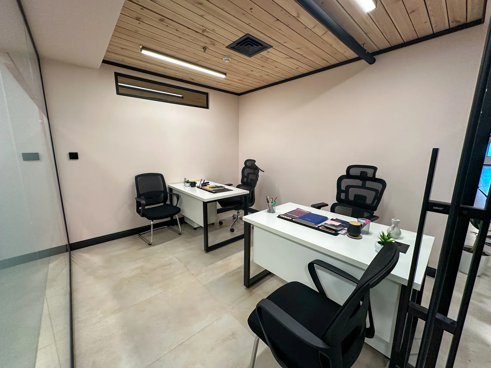 Office 17 · two desks with ergonomic and visitor chairs, a glass wall and a wooden ceiling