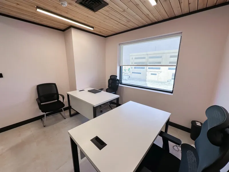 Office 37 · two desks and three chairs under a wooden ceiling, window on the right