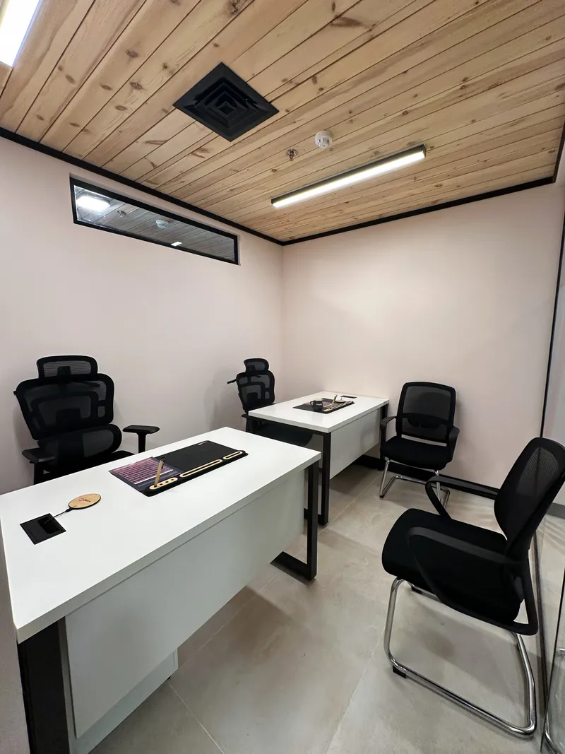 Office 1 · two desks with ergonomic chairs, two visitor chairs and a wooden ceiling