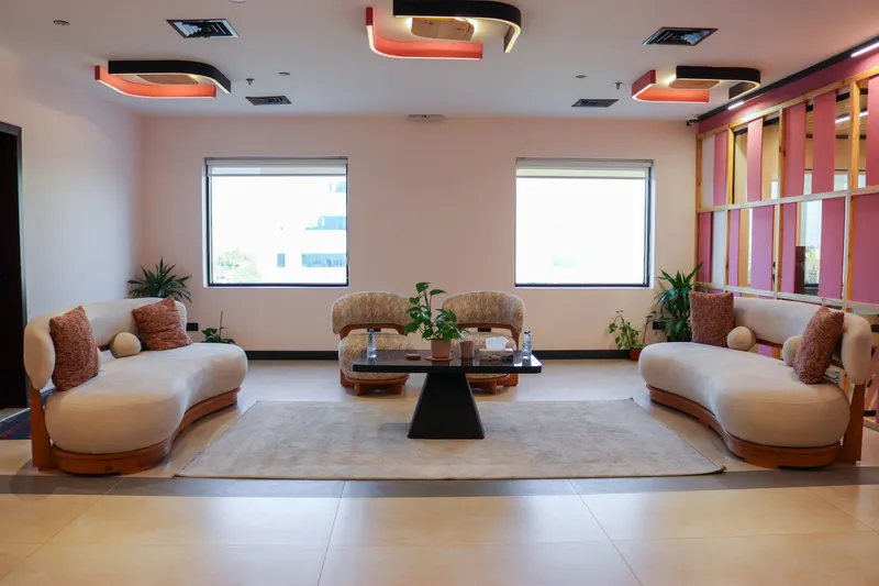 2nd floor · waiting lounge with two curved sofas, two armchairs and a black coffee table