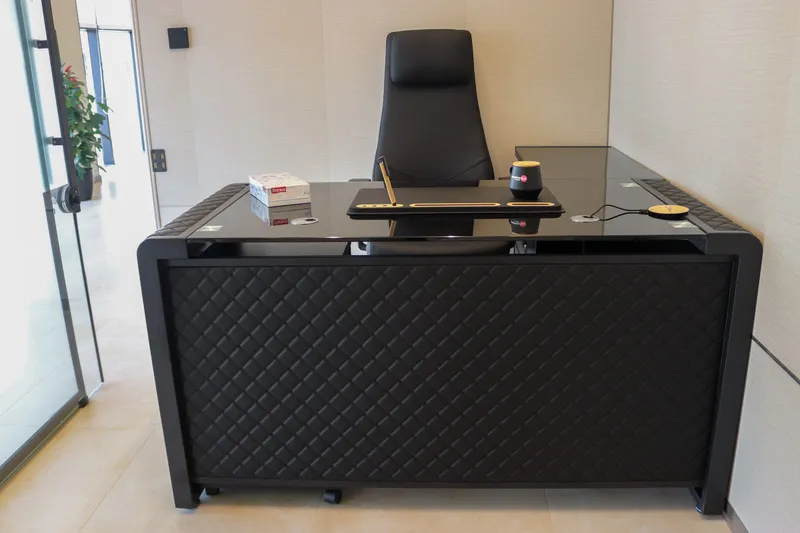 Office 63 · glass-top desk and high-back chair