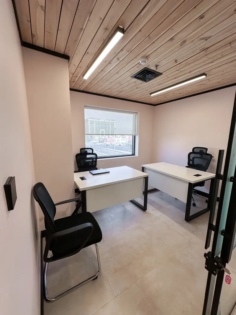 Office 37 · two desks and three chairs under a wooden ceiling, a window and a glass door