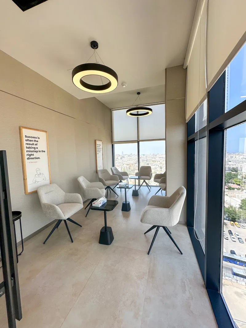 Catalyst · armchairs and low tables along a glazed wall, ring pendants overhead