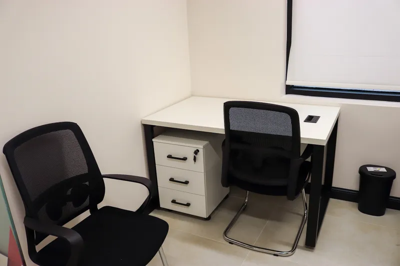 Office 13 · white desk with a drawer unit, a mesh desk chair and a visitor chair by the window