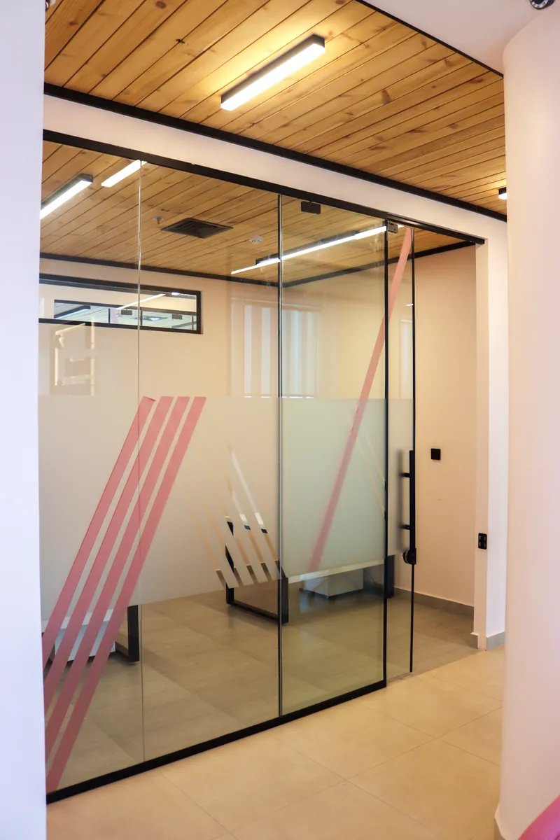 14th floor · glass-walled room with a frosted band and pink stripe graphics