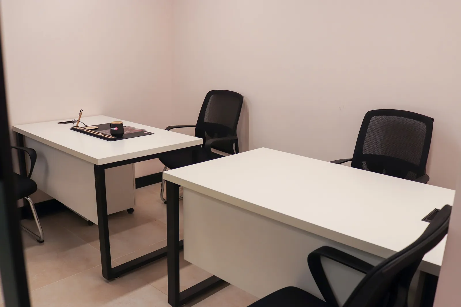 Office 2 · two white desks with black frames and mesh visitor chairs