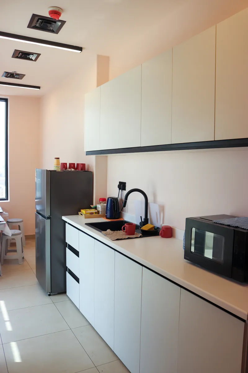 14th floor · pantry counter with sink, kettle and microwave under white wall cabinets