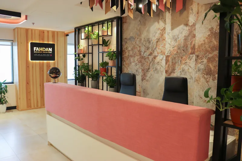 2nd floor · reception desk, plant shelving and a backlit sign on a timber wall
