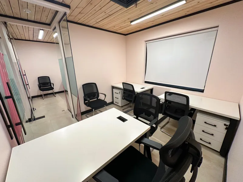 Office 13 · desks, mesh chairs and drawer units beside a glass partition with pink stripes
