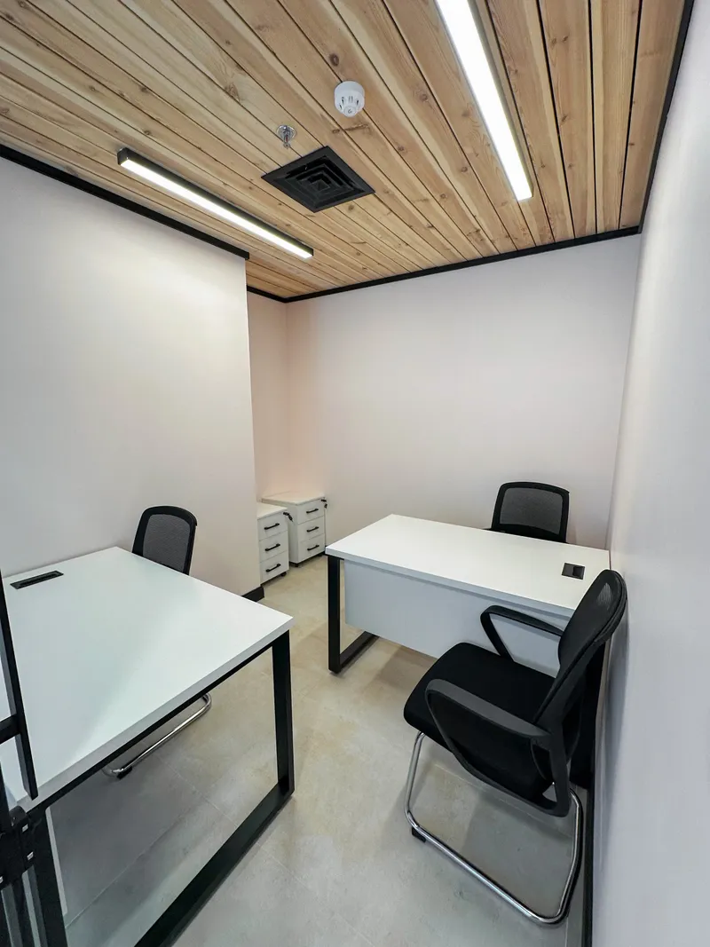 Office 35 · two desks, three chairs and two drawer pedestals under a wooden ceiling