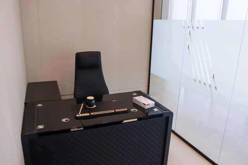 Office 62 · glass-top desk, high-back chair and frosted glass partition
