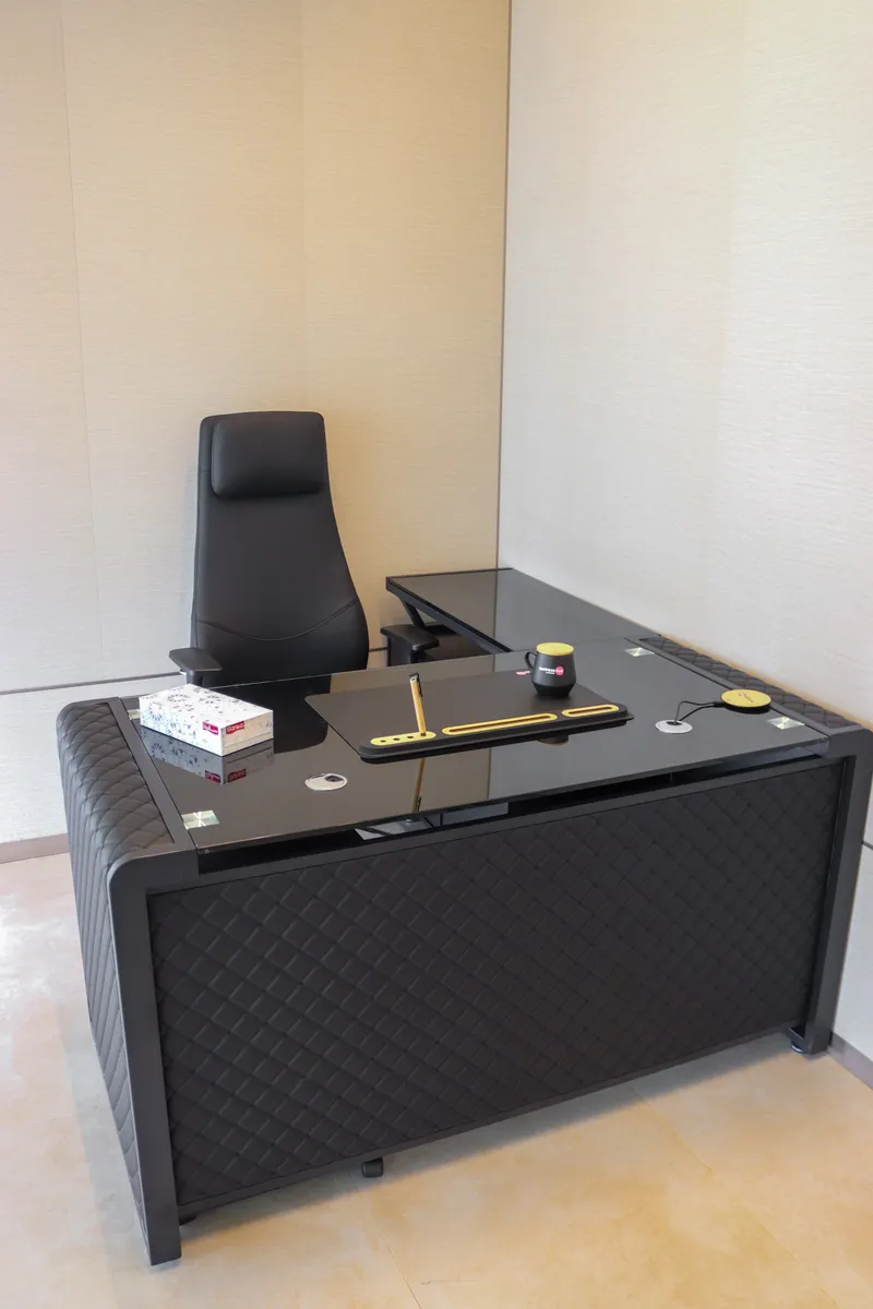 Office 63 · L-shaped desk and high-back chair
