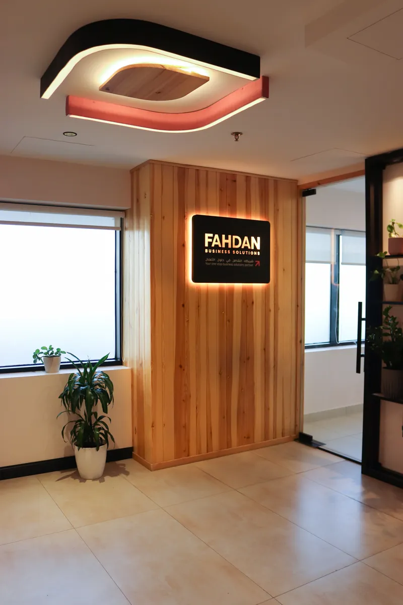 2nd floor · reception entrance with the backlit FAHDAN Business Solutions sign on a timber wall