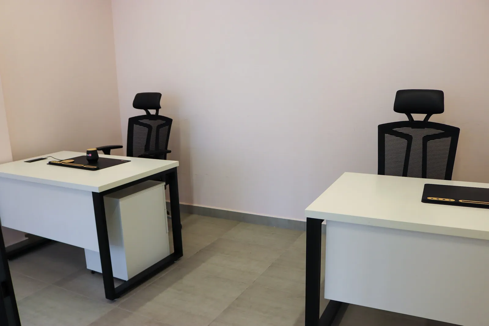 Office 68 · two desks, each with a high-back mesh chair and a desk mat