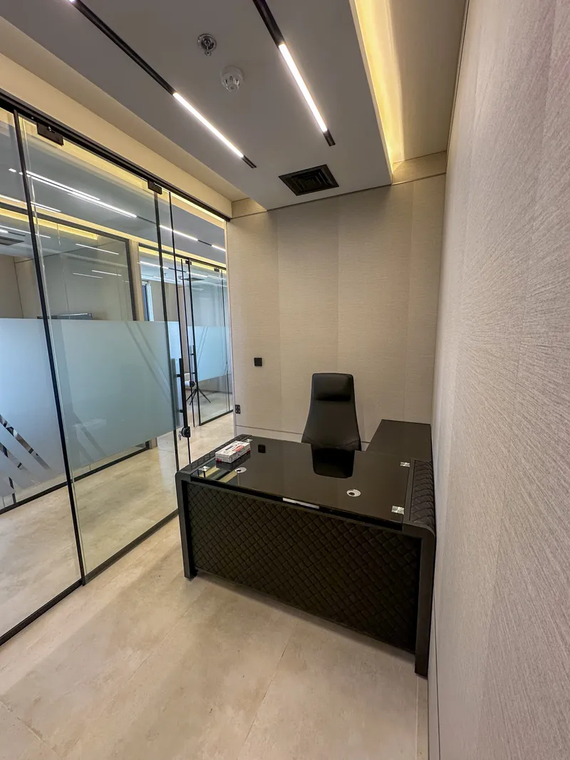 Office 61 · full room: glass-top desk, glass partition and linear ceiling lights