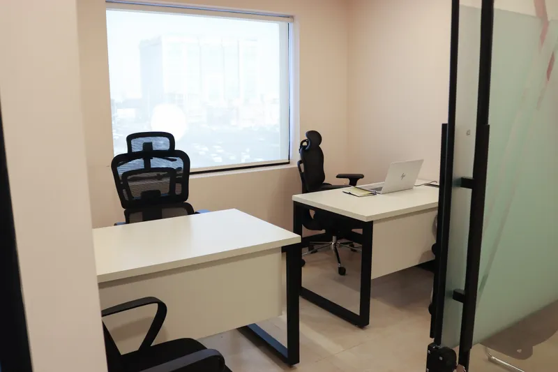 Office 42 · two desks and chairs with a window, glass door on the right