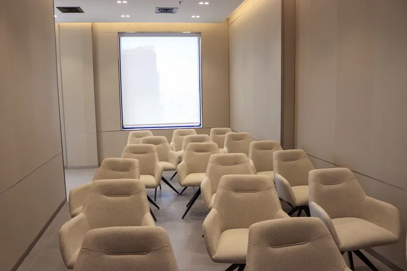 The Momentum Hall · rows of armchairs seen from the screen end, window at the back