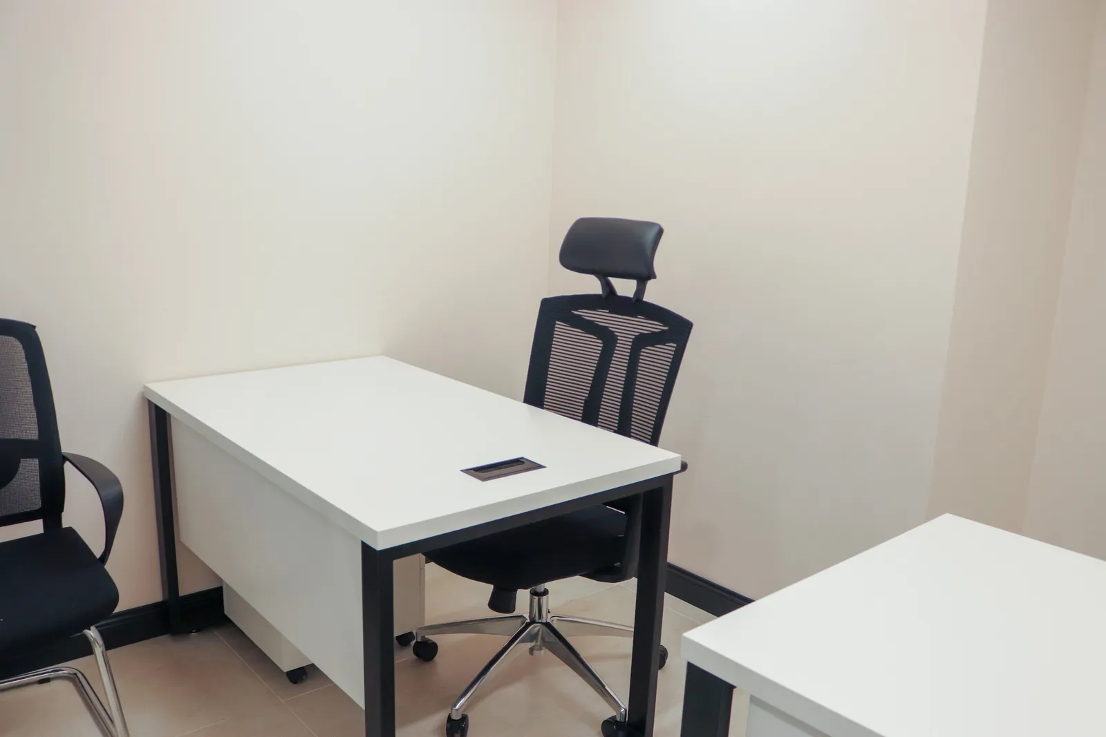 Office 18 · white desk with an ergonomic chair and a visitor chair, a second desk in the foreground