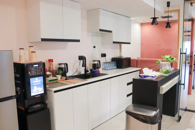 2nd floor · kitchen counter with a black sink, a microwave and pendant lights, a pink wall and sofa beyond the glass