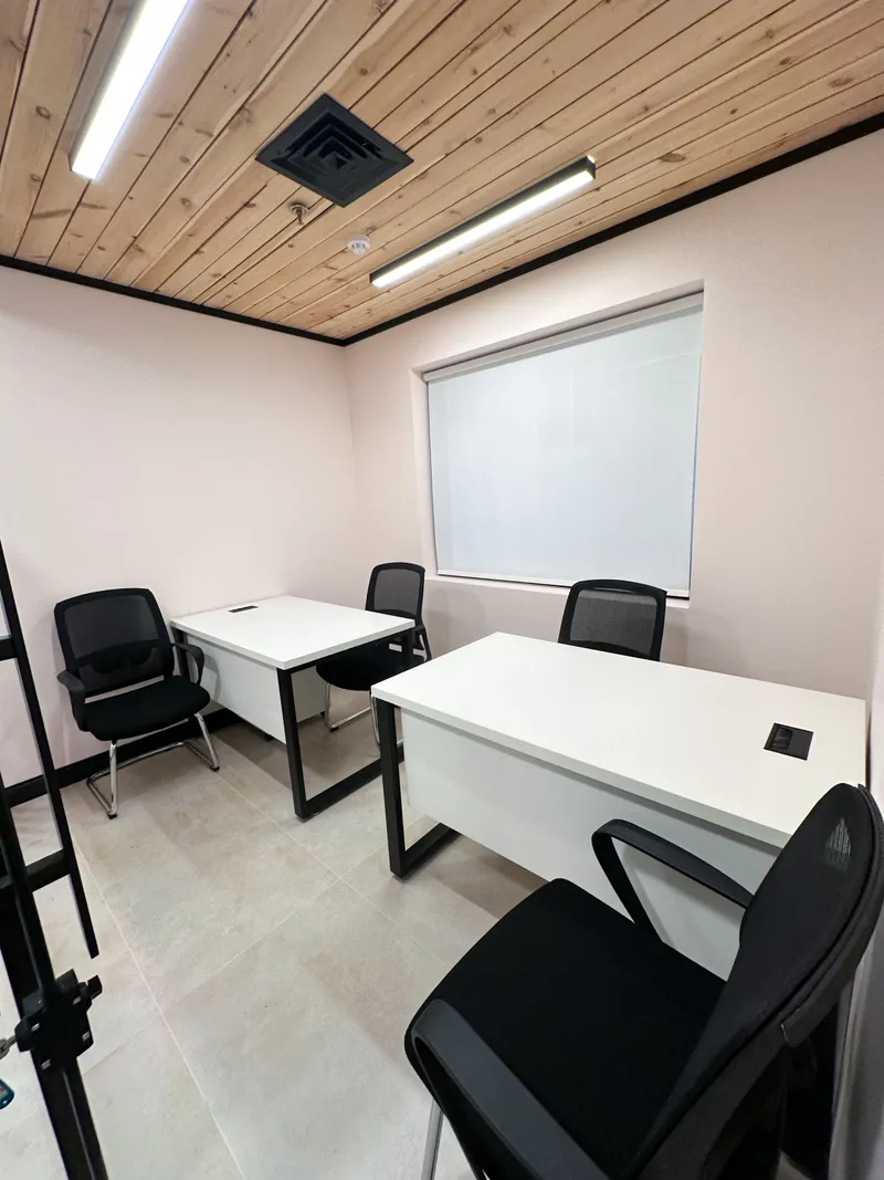 Office 30 · two white desks with mesh chairs, a roller-blind window and a wood-slat ceiling