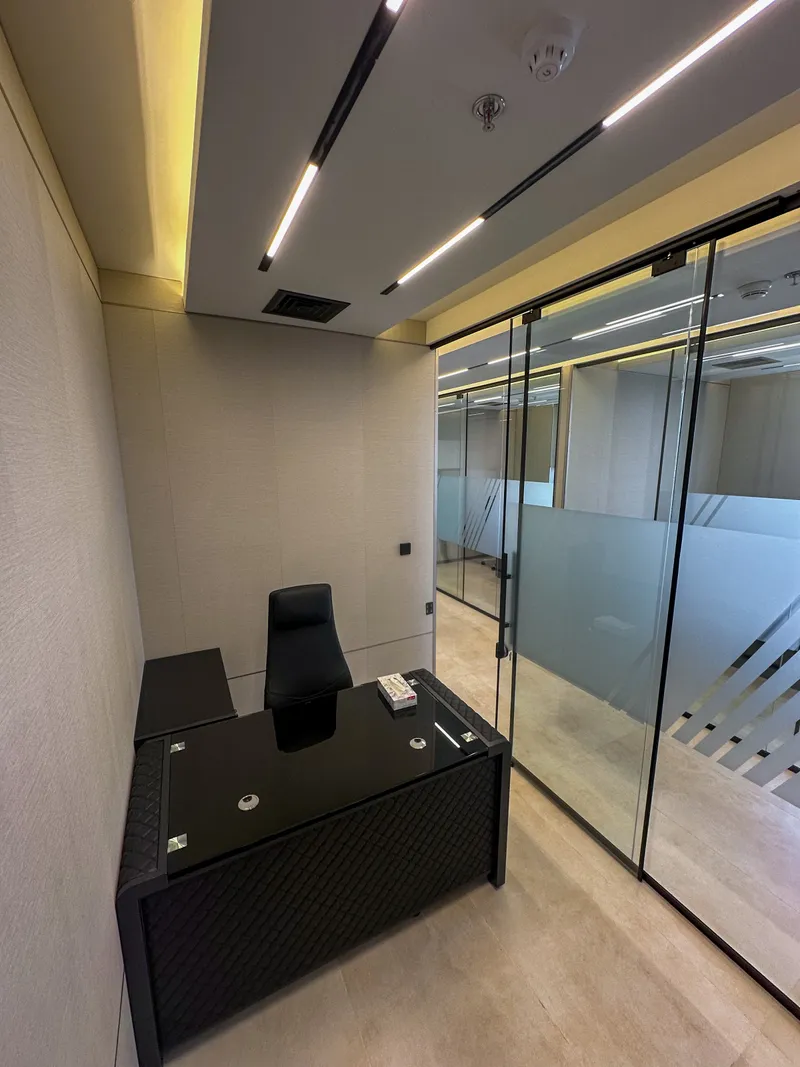 Office 60 · desk and chair beside the glass front with frosted band