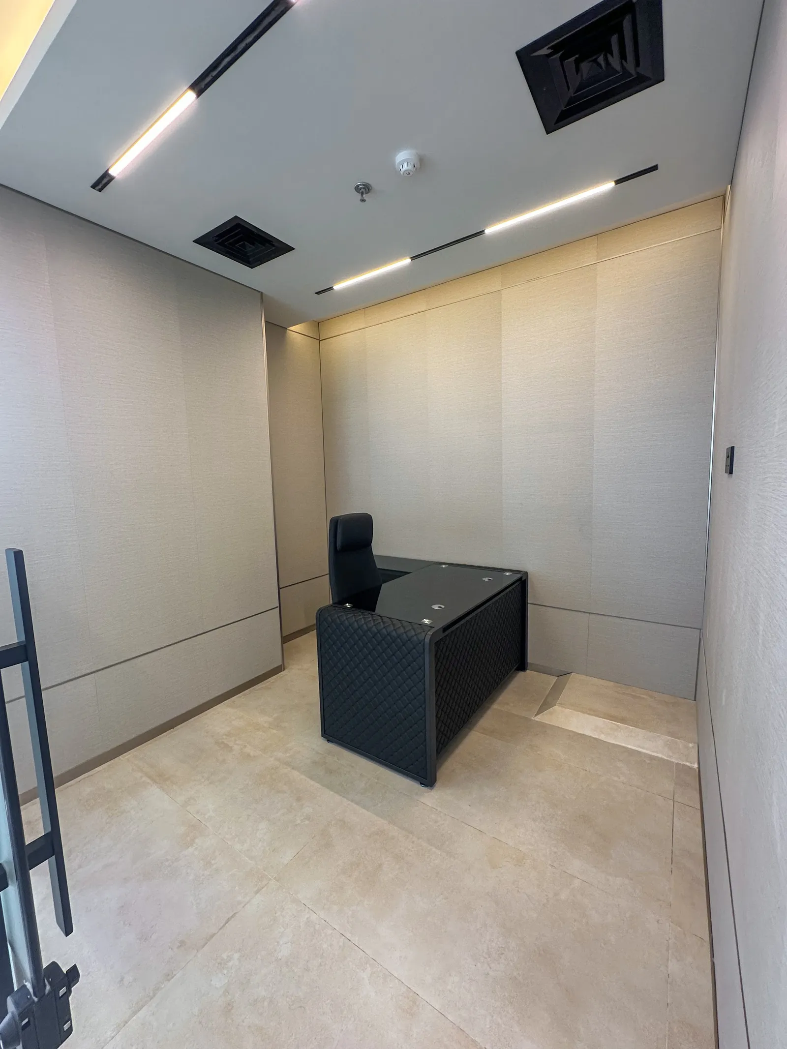 Office 58 · desk and high-back chair, panelled walls and beige tiled floor