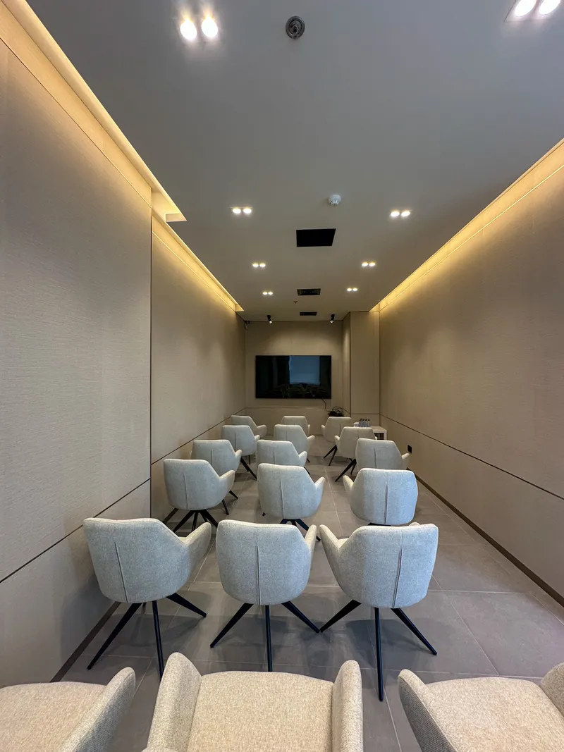 The Momentum Hall · full length of the room, rows of armchairs facing the screen