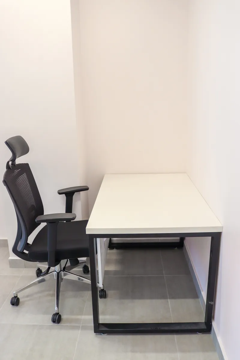 Office 69 · second desk with an open steel frame and a high-back mesh chair