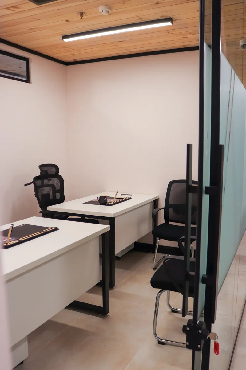 Office 1 · two desks and chairs beside a frosted glass partition under a wooden ceiling