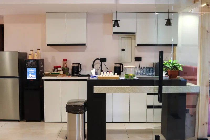 2nd floor · kitchen with white cabinets, a coffee machine, a fridge and a dark breakfast counter