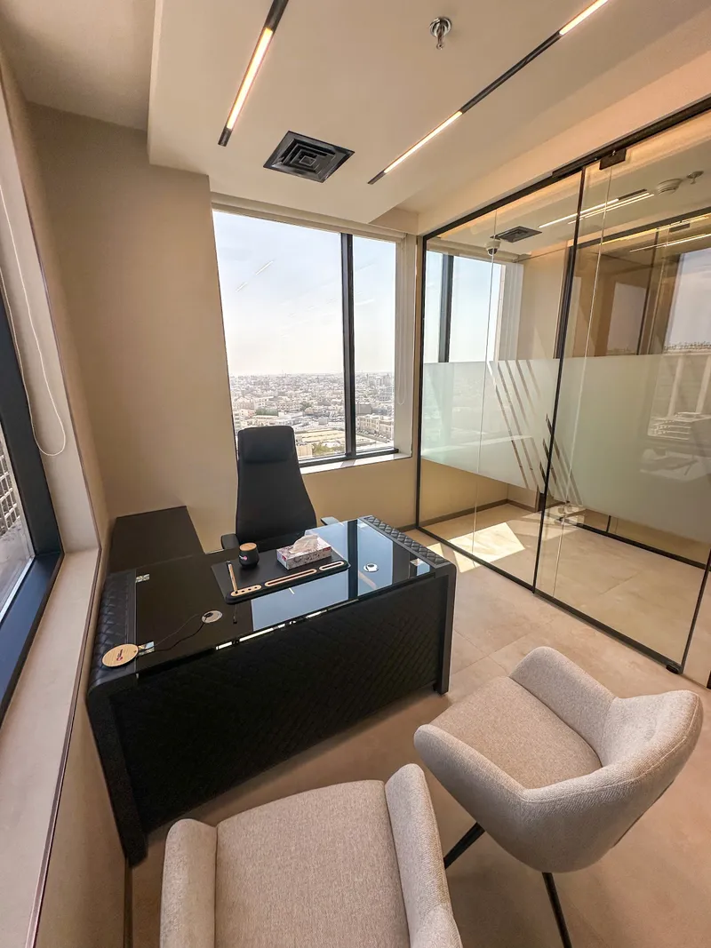 Office 53 · desk, two guest armchairs, city-view window and glass frontage